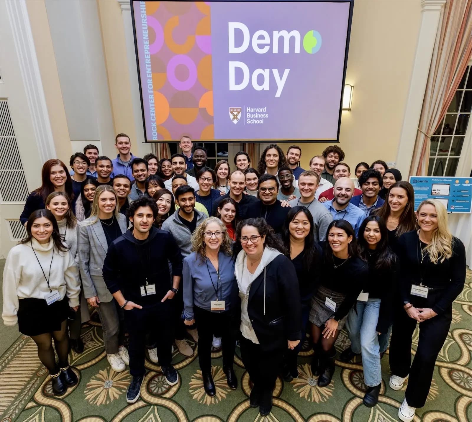 Michael standing in crowd of HBS Demo Day students.